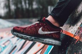 man in dark red sneaker close up on blurred background