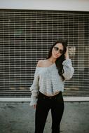 fashionable girl in black jeans and sunglasses