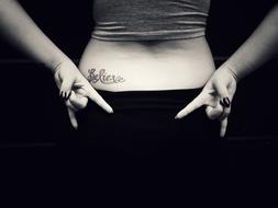 tattoo on girl back in black and white background