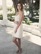 girl in white dress posing on the street