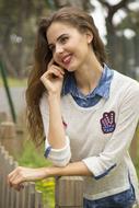 young woman near the fence on a blurred background