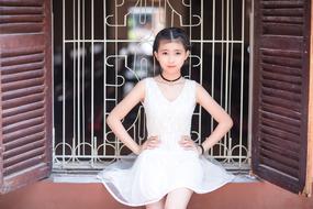 little girl posing near the window