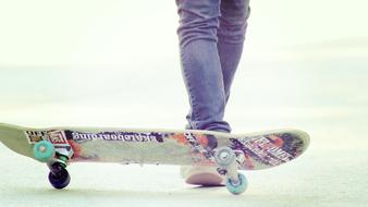 teen legs in jeans and skateboard