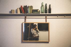 Woman taking photo of the mirror and colorful decorations