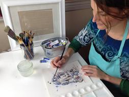 woman artist at work at the table