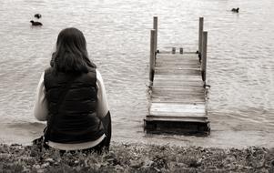 woman near waters in idyllic black white landscape