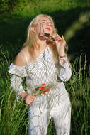 relaxed Girl rests on meadow