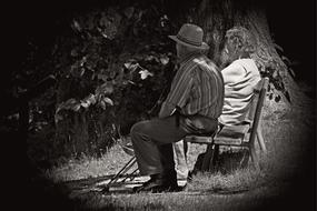 black and white, elderly couple on a park bench