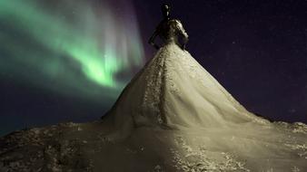 bride on the background of the northern lights