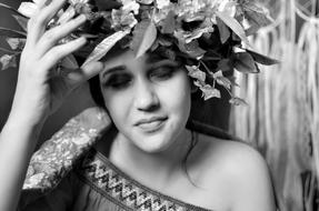 Black and white portrait of the woman with closed eyes, with the beautiful flowers and leaves