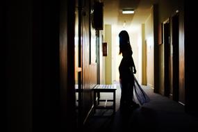 Silhouette of the woman in dark room with lights