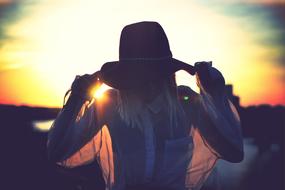 woman in hat at Sunset