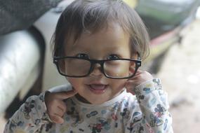 cute baby in women's glasses