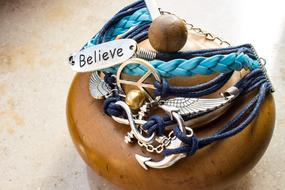Bracelet with Believe shield and hippie symbols