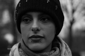 black and white, girl with piercings in a hat