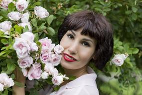 short hair girl and rose bush