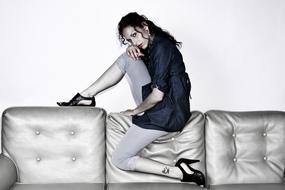 Posing woman with make-up, on the shiny couch