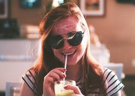 young woman drinking smoothie