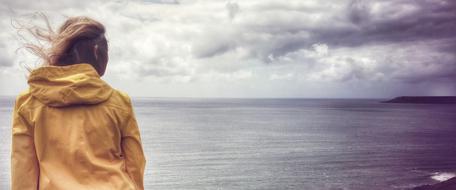 girl in Yellow coat on Sea coast