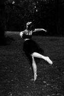 black and white photo of a ballet dancer in a park