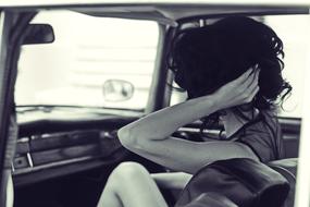 photo of brunette in a vintage car