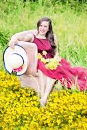 happy girl on the field with yellow flowers