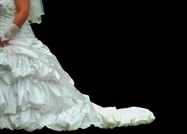 side view of Bride in long fluffy white dress at darkness