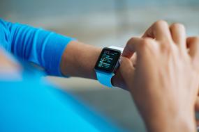 photo of a blue smart watch on a girl's hand