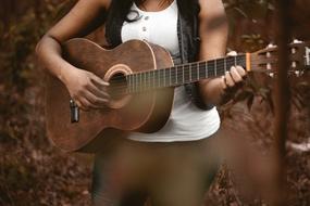 girl plays Guitar outdoor, detail