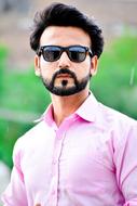 man in a pink shirt and sunglasses