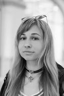 black and white photo of a girl with glasses on her head