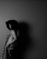 black and white photo of an african model at the wall