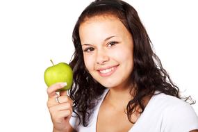 Apple in hand of pretty overweight girl