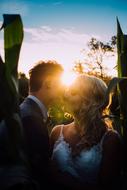 Man Woman kiss sun