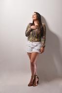 Brazilian fashion model in a blouse and shorts