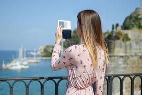 girl looks in the mirror on the promenade