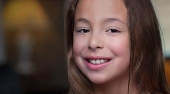 portrait of a young girl of natural beauty on a blurred background