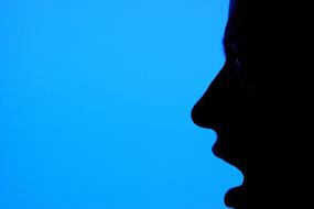 female silhouette in profile on a blue background