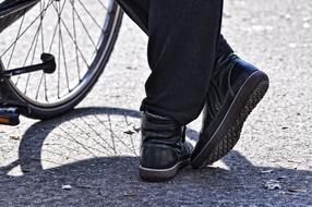 woman's shoe and bicycle wheel