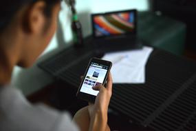 woman reading news in smartphone