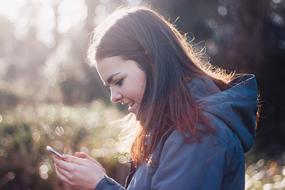 smiling Girl with cellphone outdoor