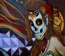 Beautiful and colorful graffiti with the skull woman, on the wall