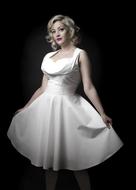 blonde in a white dress on a black background