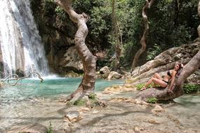 woman in bikini near waterfall