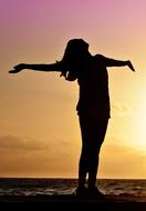 girl with outstretched arms on a background of the sea