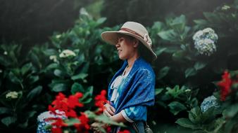 Portrait of Smiling Woman at blooming shrubs