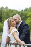 bride with groom in nature on a blurred background