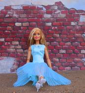 Blonde Barbie Doll at brick wall