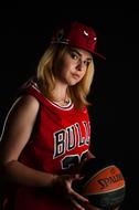 Portrait of sportive girl holding basketball