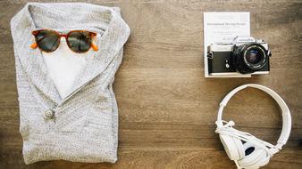 Headphones, Photo camera and glasses on table